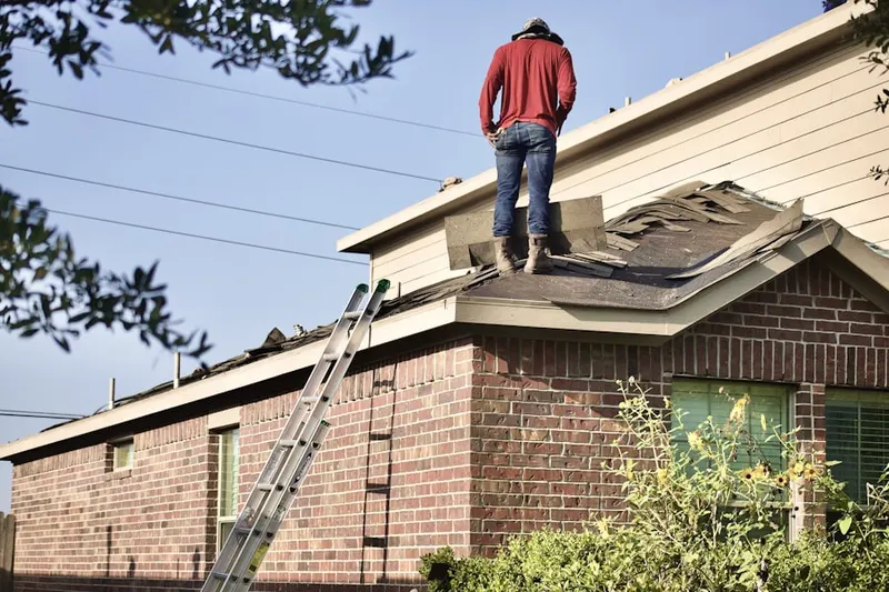 Professional roofer working on a residential roof in New Iberia